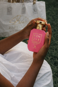 Kenzie Watermelon On Ice perfume bottle held by a person, featuring bold pink packaging.